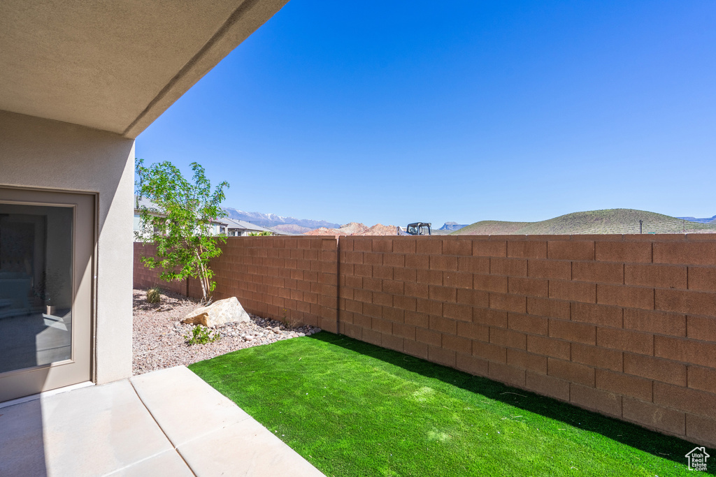 View of yard with a mountain view and a patio area