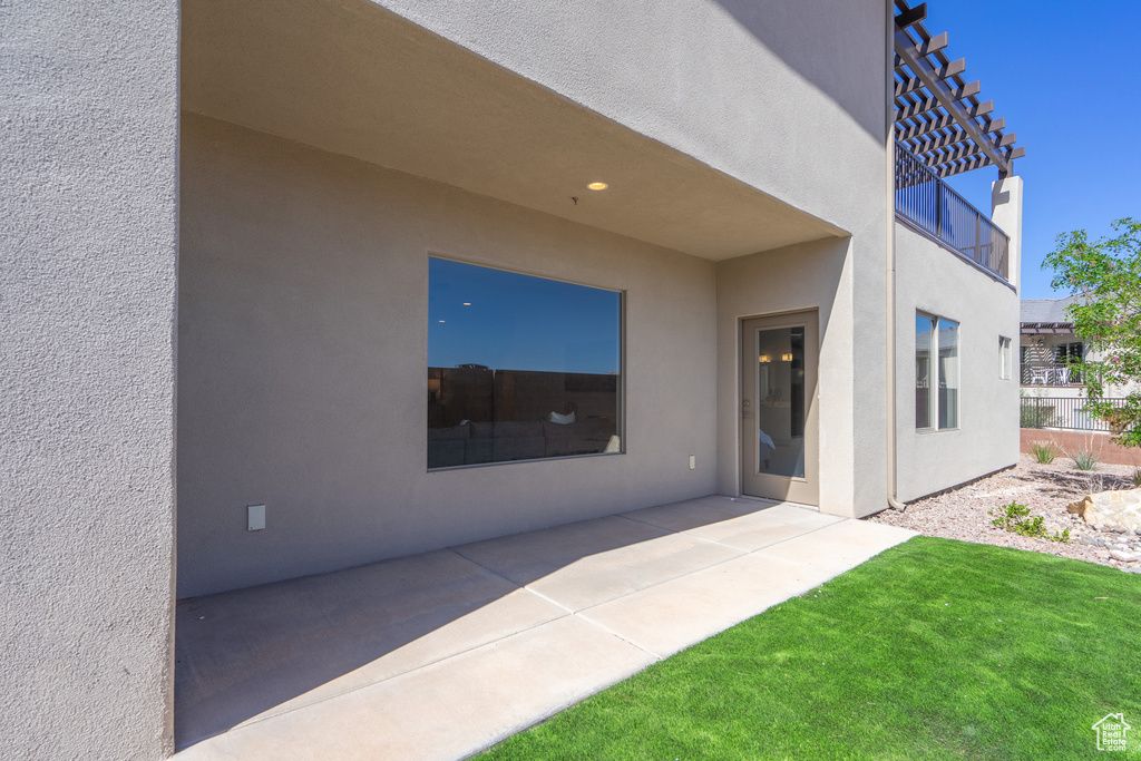 Rear view of property featuring a lawn and a patio area