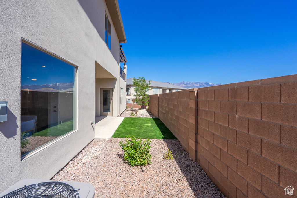 View of yard with a mountain view and a patio area
