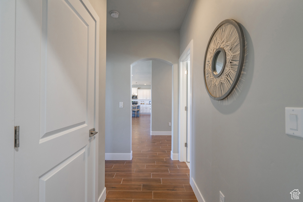 Hall with dark hardwood / wood-style floors