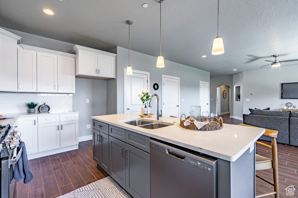 Kitchen with stainless steel appliances, white cabinetry, and sink