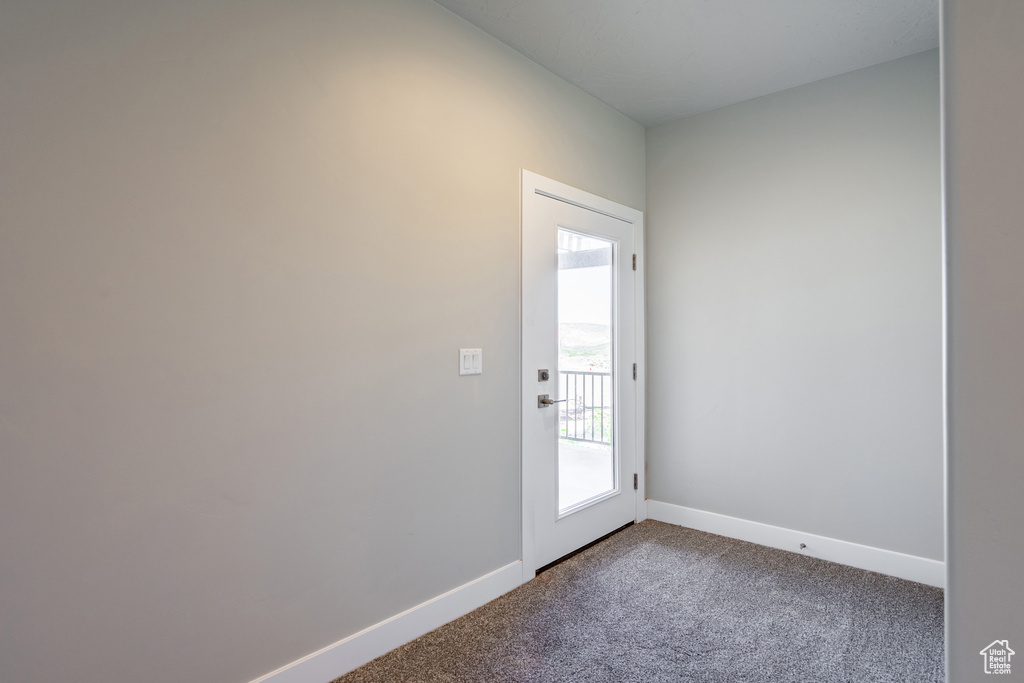 Doorway to outside with carpet floors