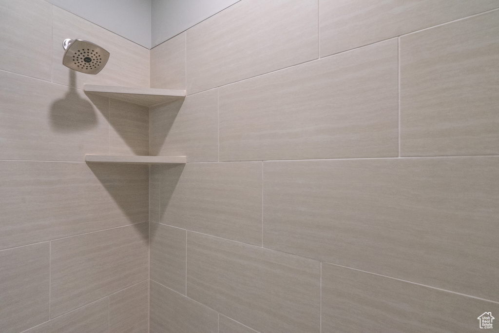 Room details featuring a tile shower