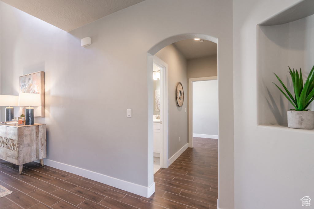 Corridor with dark hardwood / wood-style flooring