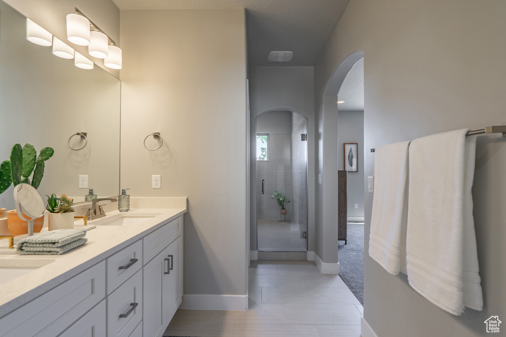 Bathroom featuring vanity and a shower with shower door
