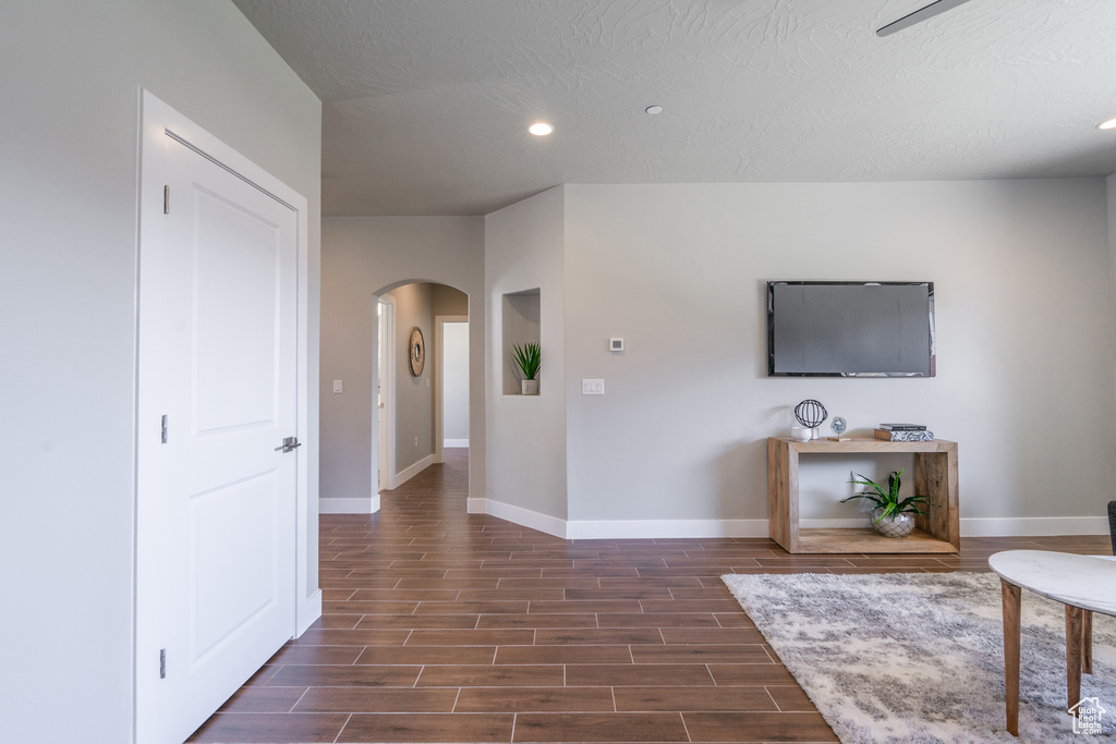 Interior space featuring a textured ceiling and dark hardwood / wood-style floors