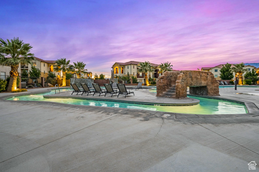 Pool at dusk with a patio area