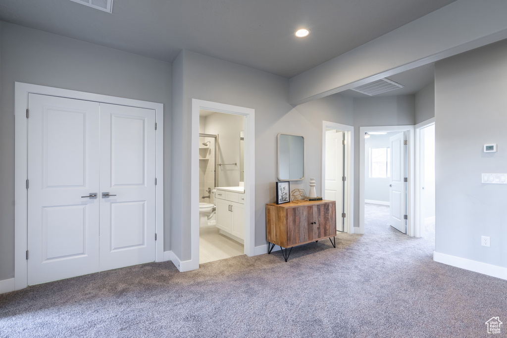 Interior space with ensuite bathroom and a closet