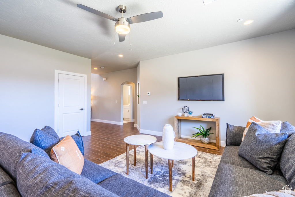 Living room featuring ceiling fan and hardwood / wood-style floors