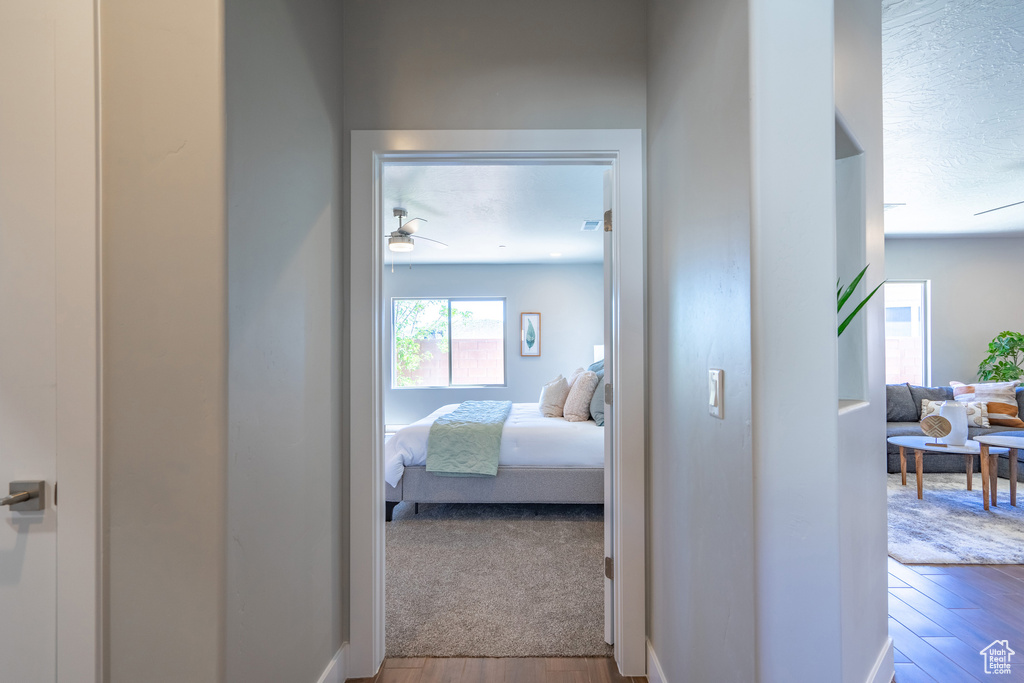 Hallway featuring wood-type flooring and a textured ceiling