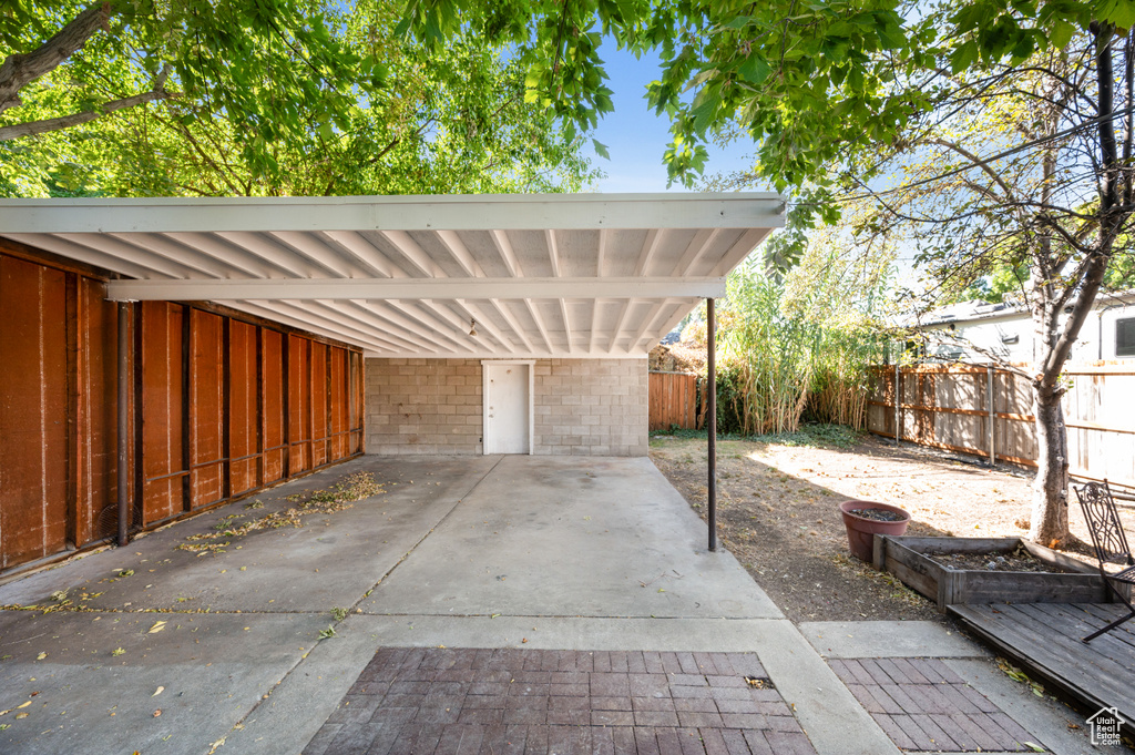 View of vehicle parking featuring a carport