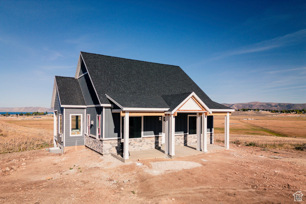 View of front of home featuring a rural view and a mountain view