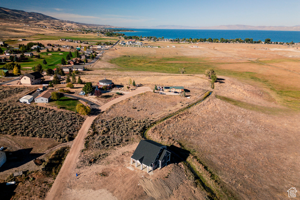 Birds eye view of property featuring a water view and a rural view