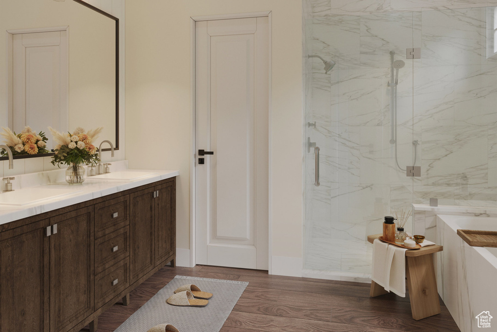 Bathroom with vanity, hardwood / wood-style floors, and a shower with shower door