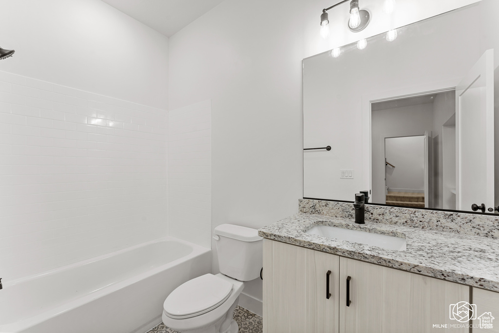 Full bathroom featuring shower / washtub combination, vanity, and toilet