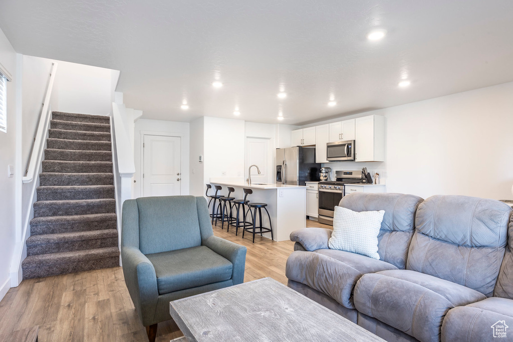 Living room featuring light hardwood / wood-style floors and sink