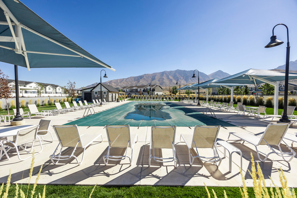 View of pool with a patio and a mountain view