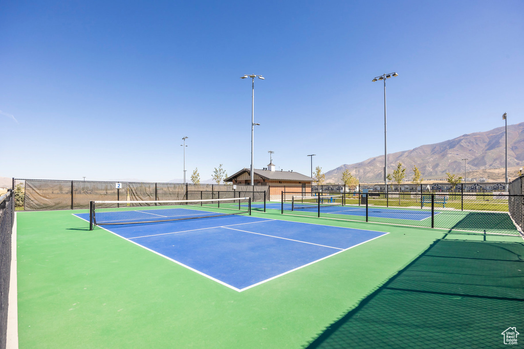 View of tennis court with a mountain view