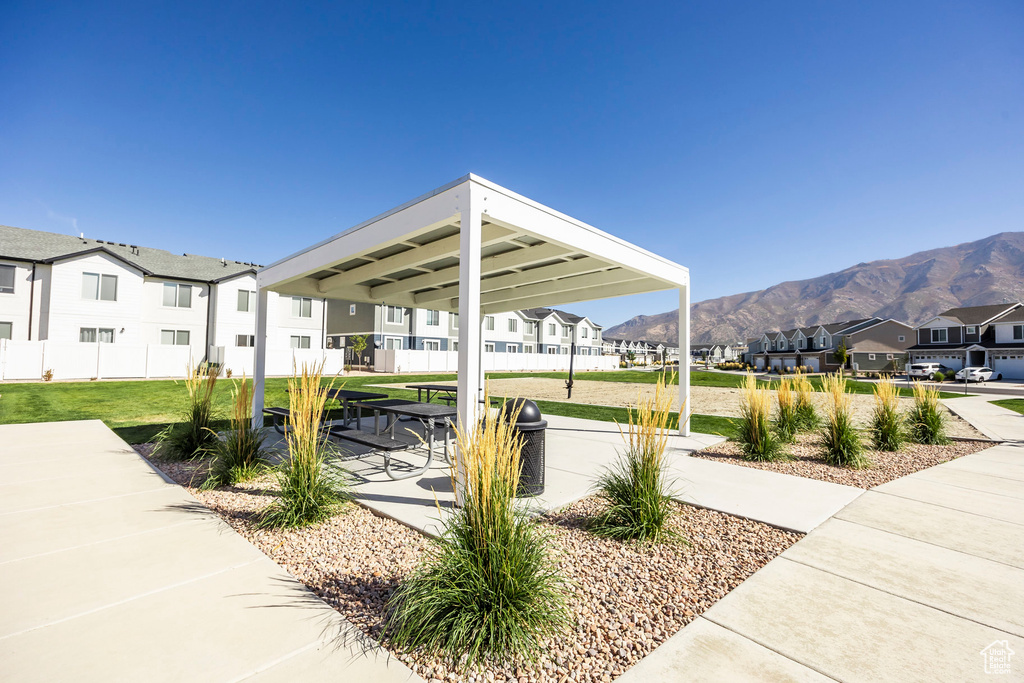 Surrounding community with a lawn and a mountain view