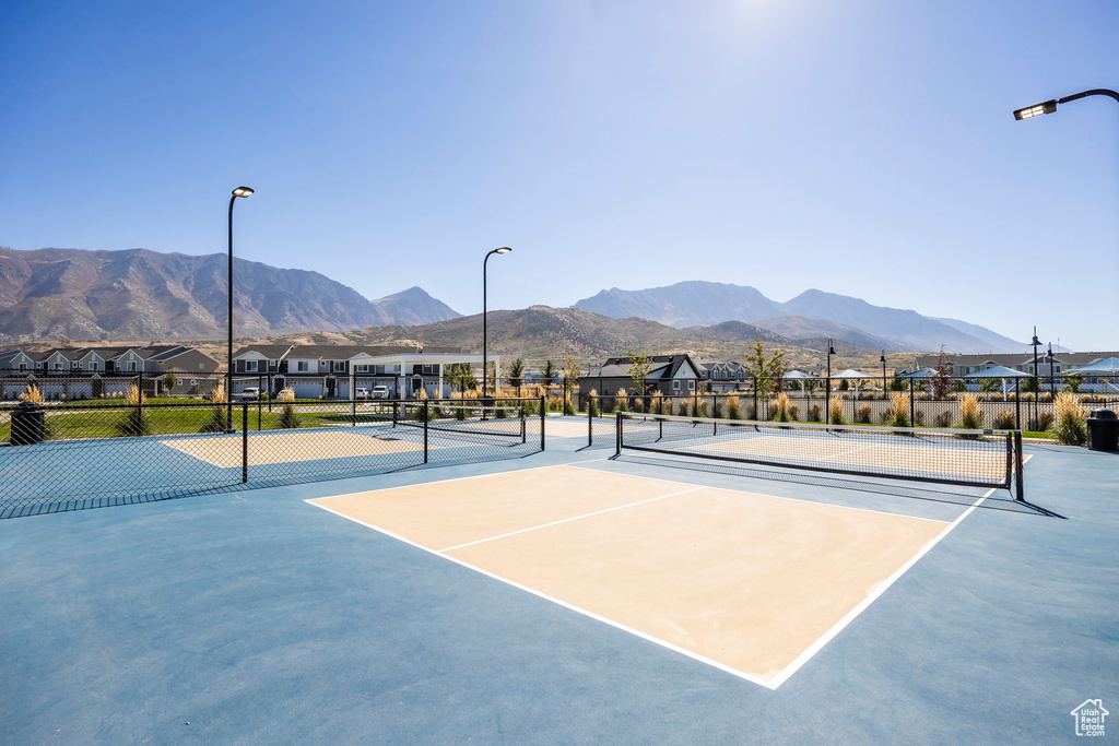 View of tennis court with a mountain view