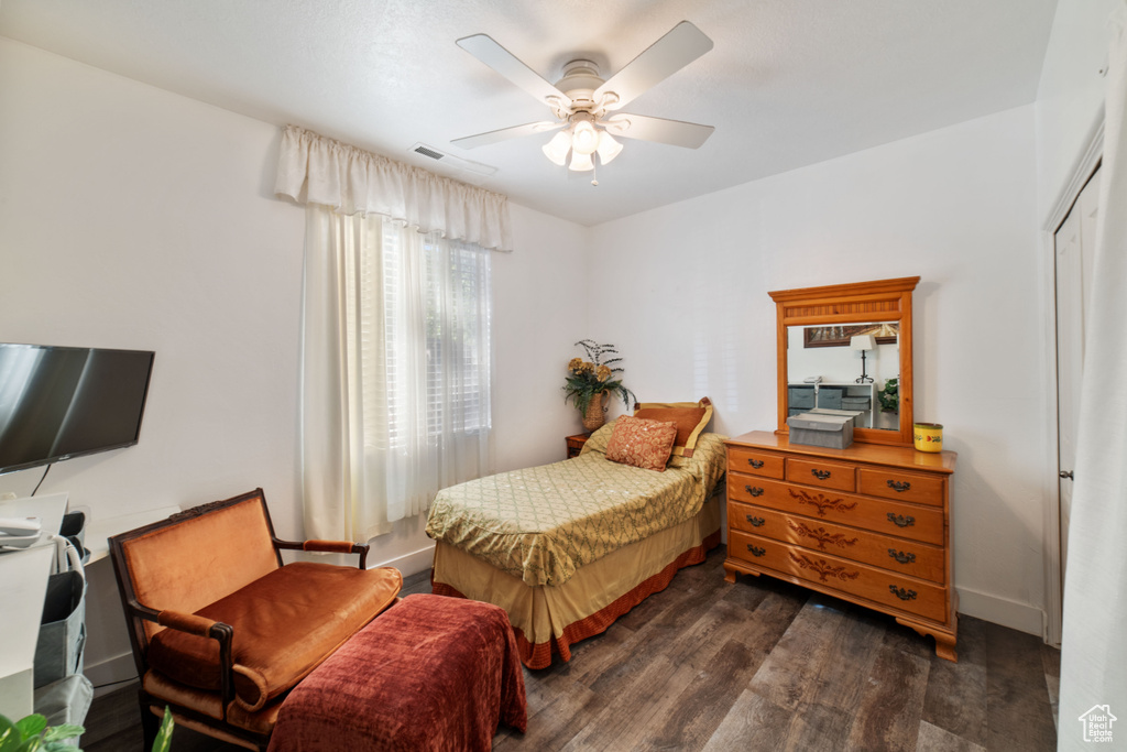 Bedroom with ceiling fan and dark hardwood / wood-style flooring