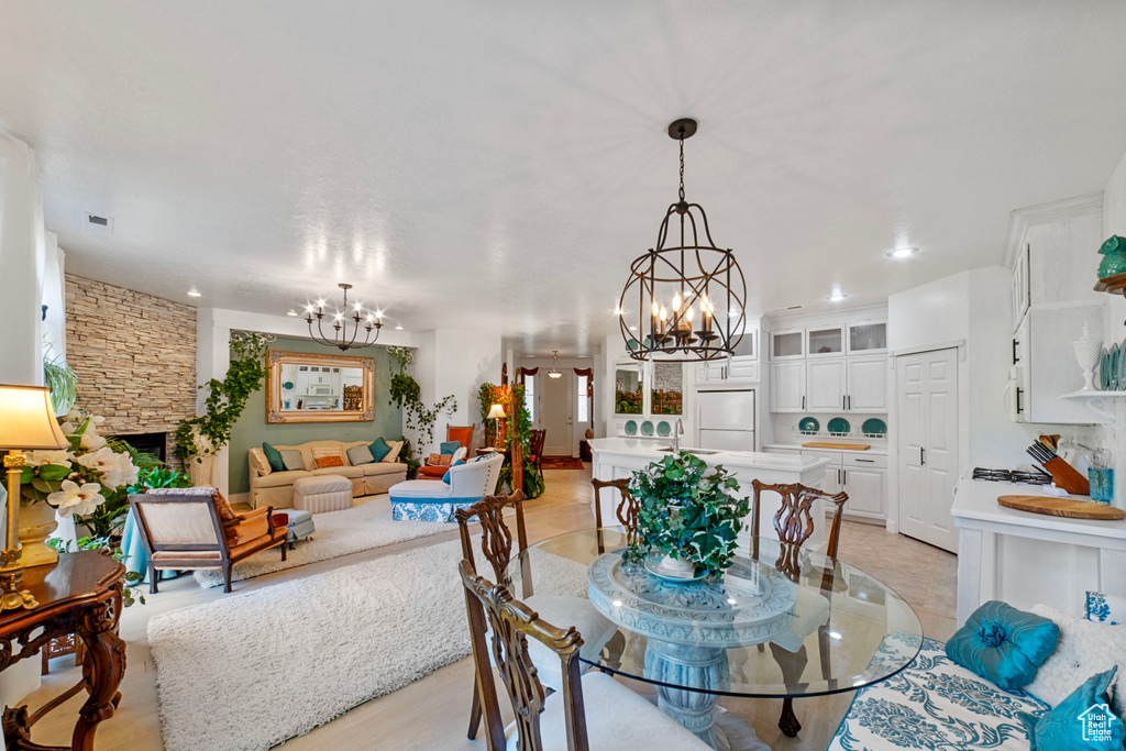 Dining room featuring an inviting chandelier and light wood-type flooring