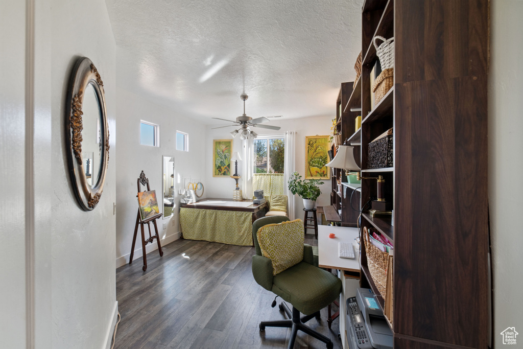 Office featuring ceiling fan, dark hardwood / wood-style floors, and a textured ceiling