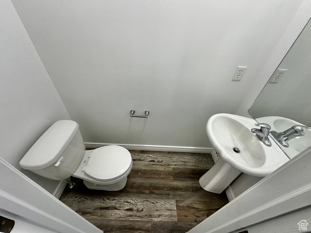 Bathroom with wood-type flooring and toilet