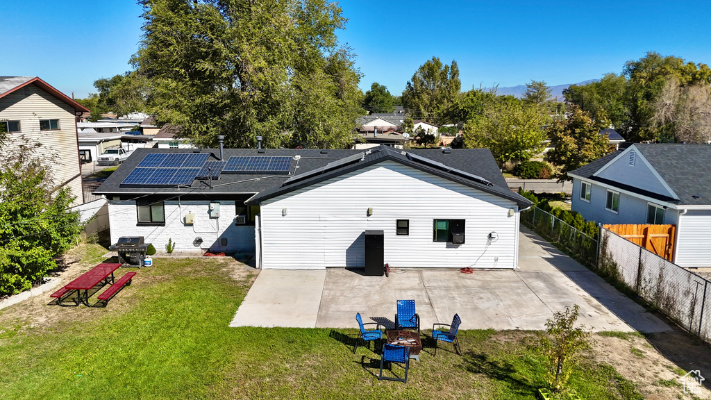 Back of property featuring a yard and a patio