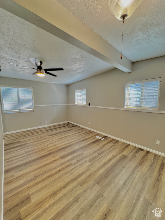 Spare room with plenty of natural light and light hardwood / wood-style floors