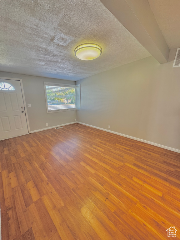 Entryway featuring a textured ceiling and light hardwood / wood-style floors