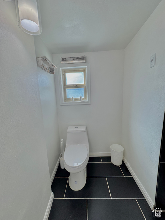 Bathroom with toilet and tile patterned floors