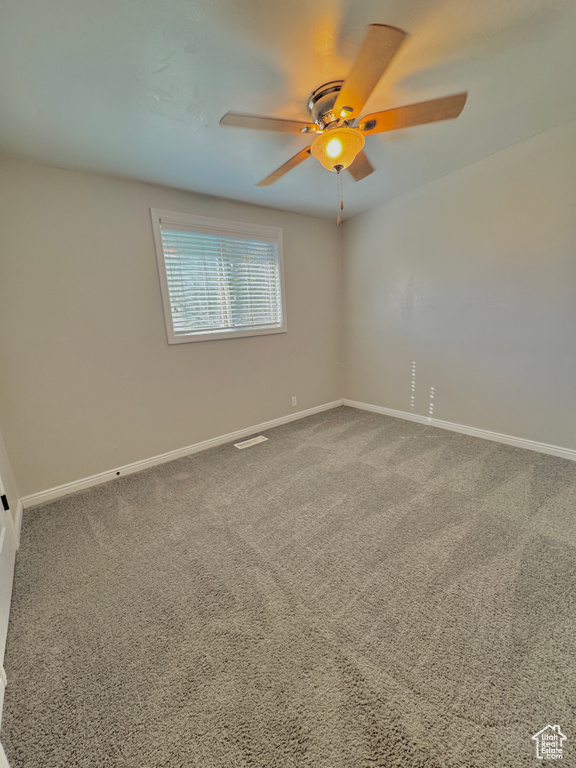 Spare room with carpet and ceiling fan