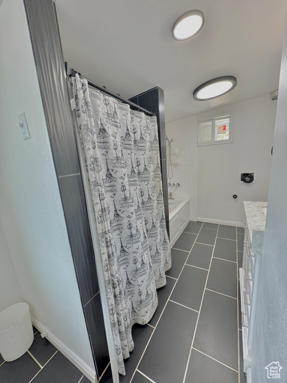 Bathroom with shower / tub combo with curtain, vanity, and tile patterned flooring