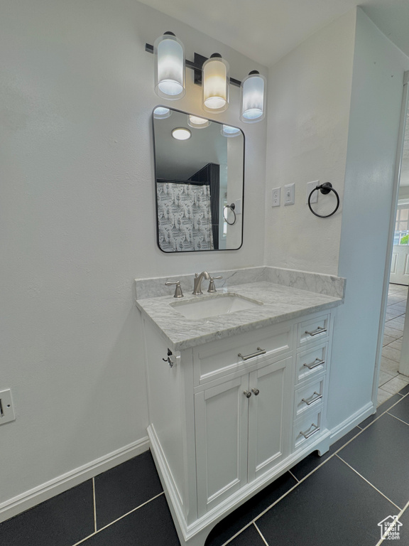 Bathroom with tile patterned flooring and vanity