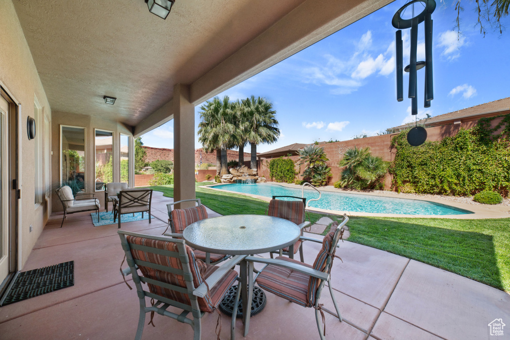 View of patio with a fenced in pool