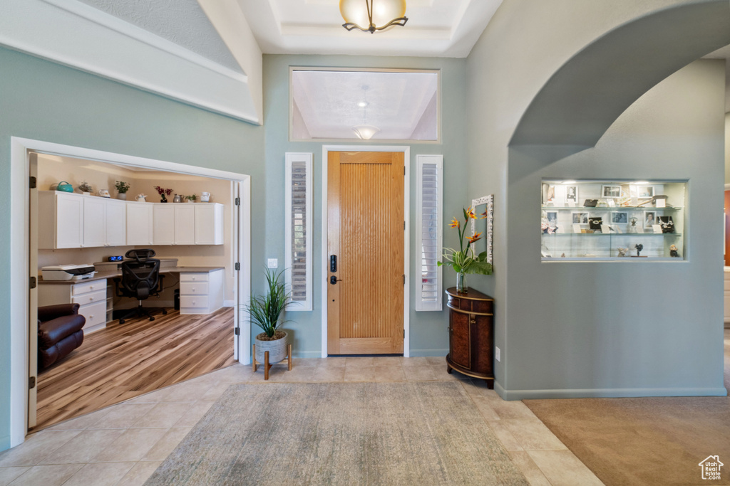 Foyer with built in desk and light hardwood / wood-style floors