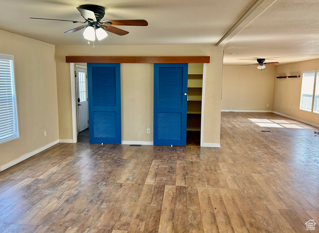 Spare room with hardwood / wood-style floors and ceiling fan