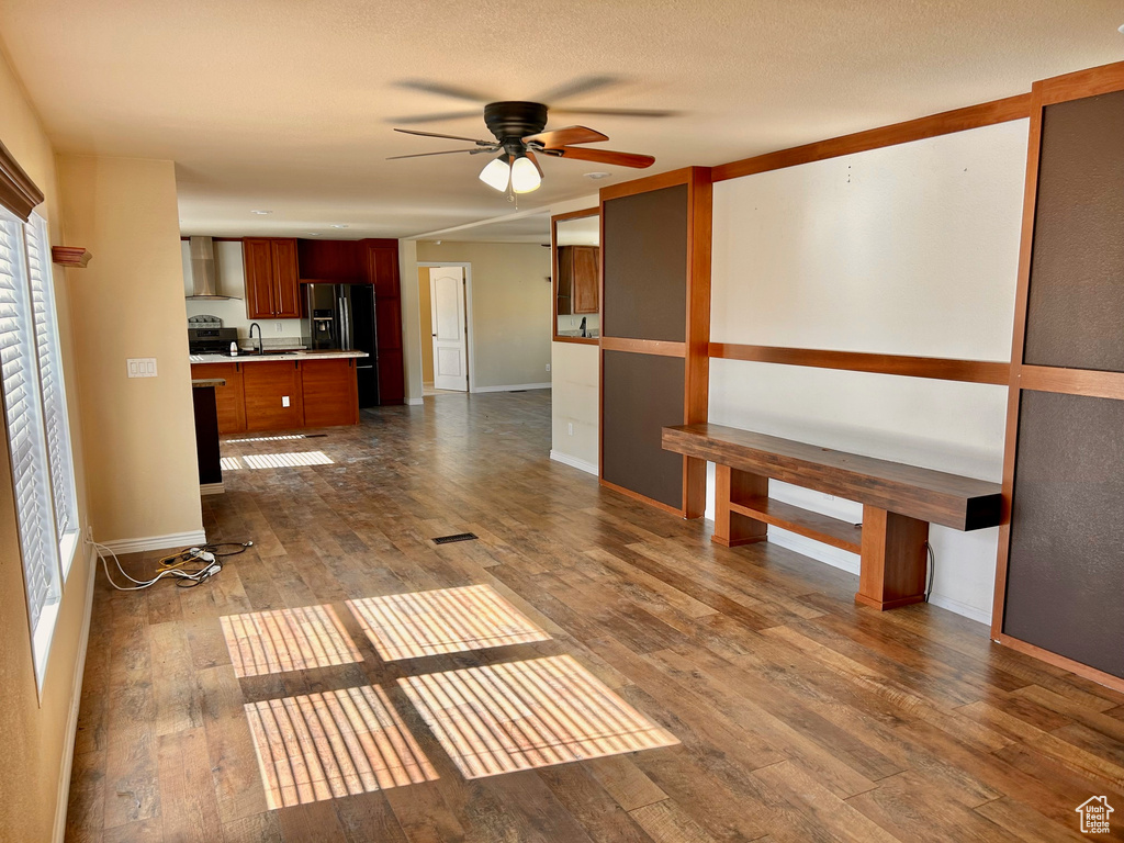 Interior space with a healthy amount of sunlight, dark hardwood / wood-style flooring, ceiling fan, and sink