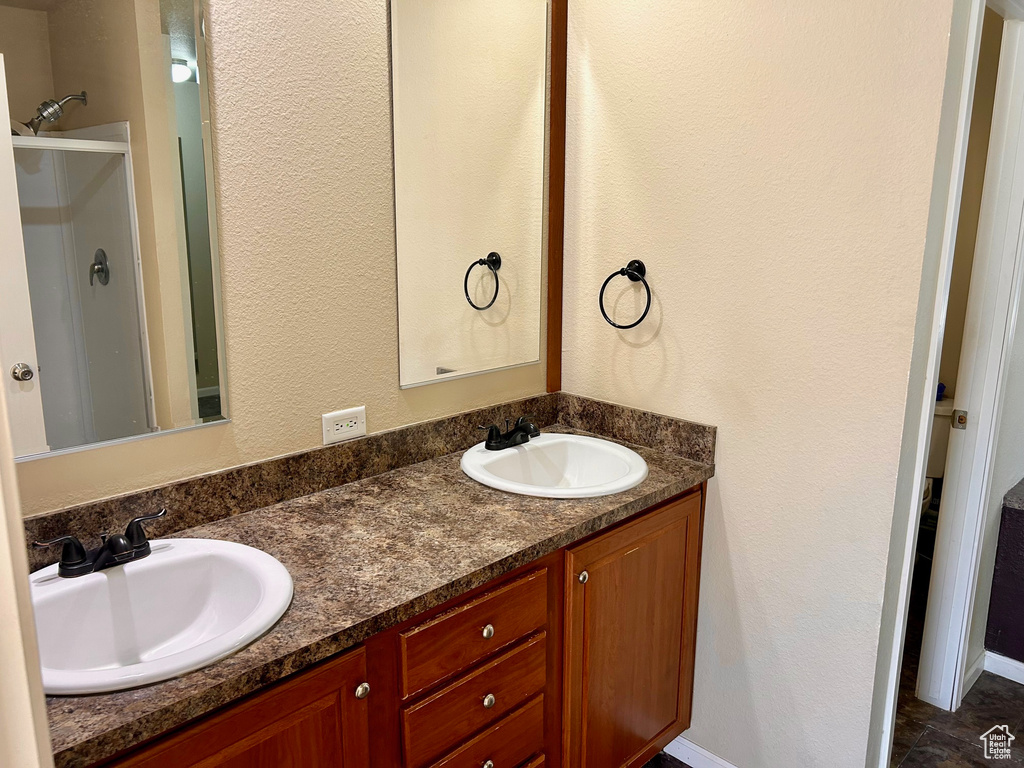 Bathroom featuring vanity and an enclosed shower