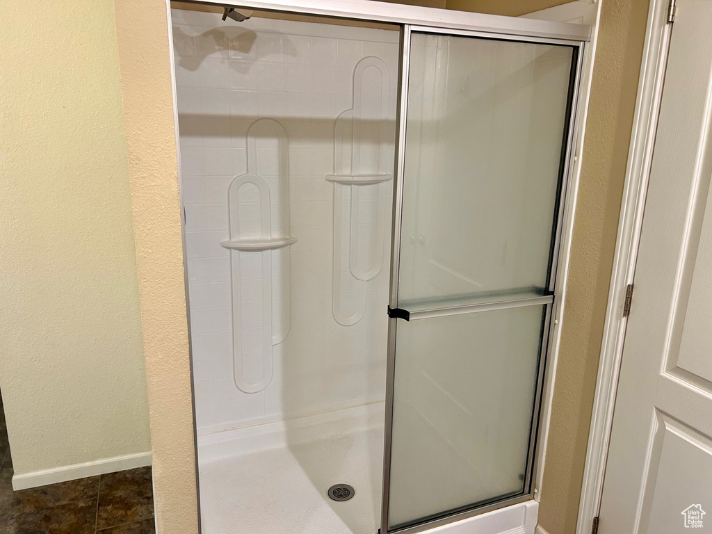 Bathroom featuring tile patterned flooring and an enclosed shower