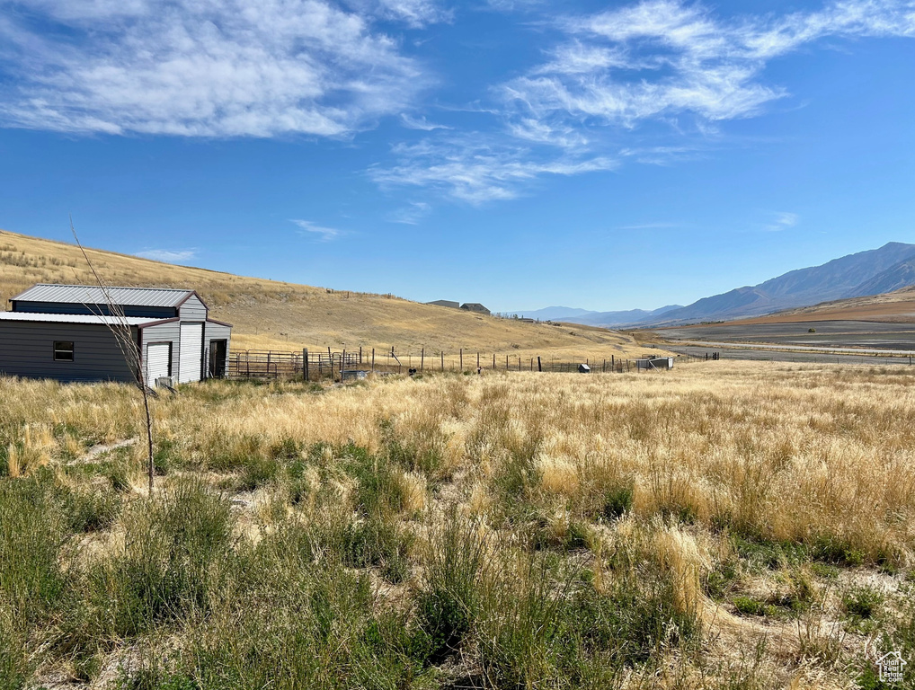 Property view of mountains with a rural view