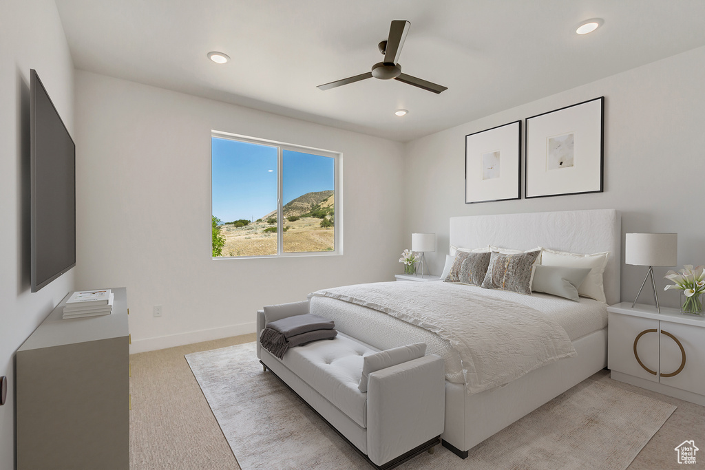 Carpeted bedroom featuring ceiling fan