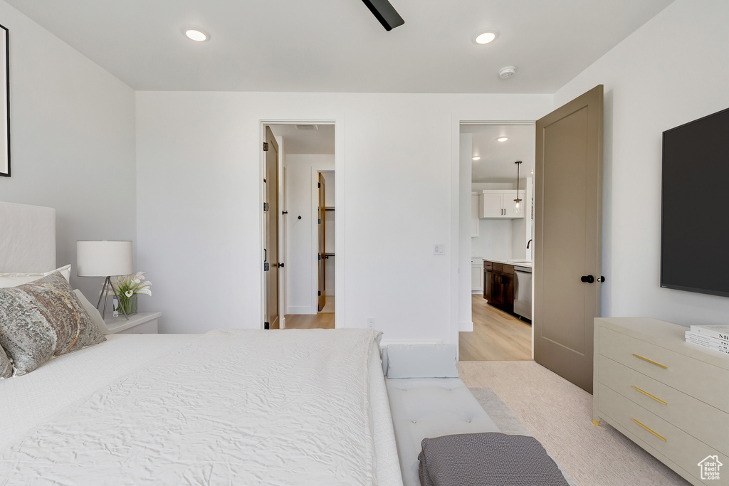 Bedroom featuring connected bathroom, light wood-type flooring, and sink