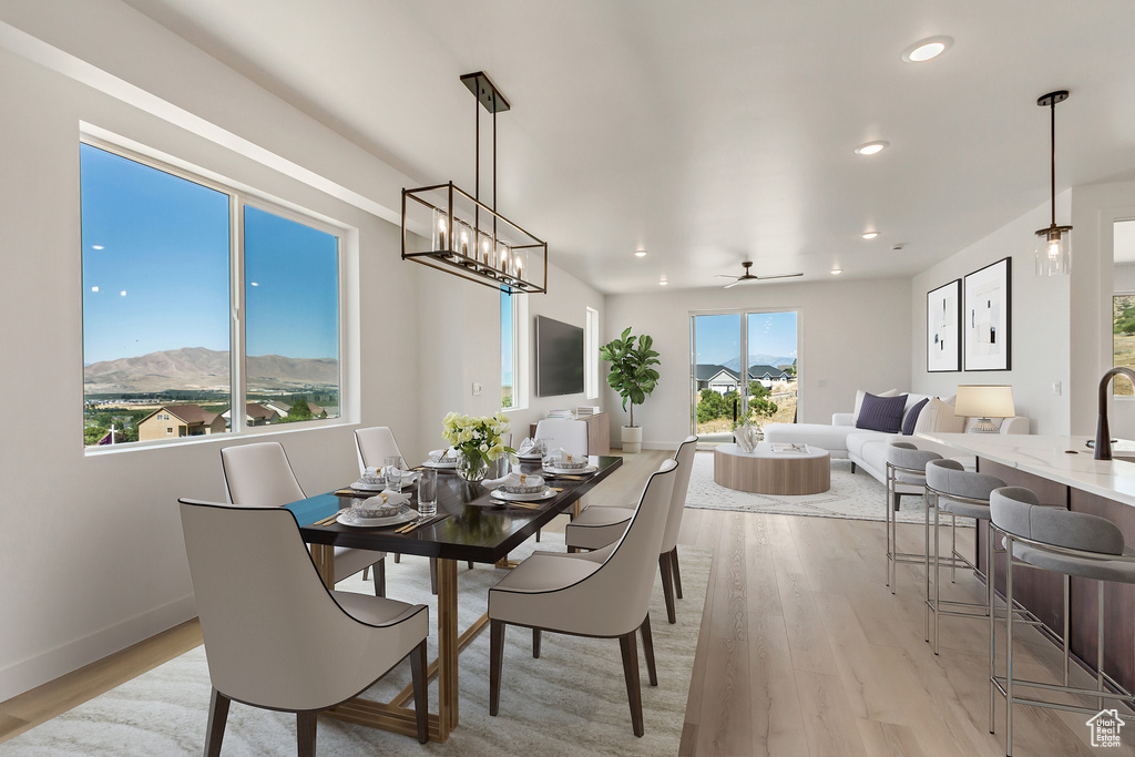 Dining room featuring ceiling fan, a mountain view, and light wood-type flooring