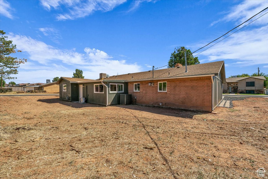 Back of house with central AC