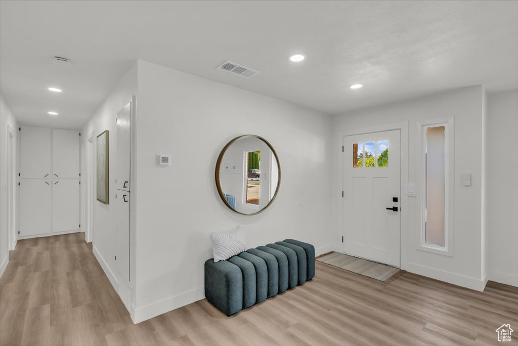 Foyer entrance with light wood-type flooring