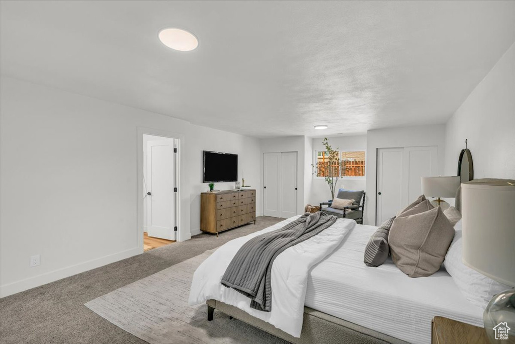 Bedroom with light colored carpet