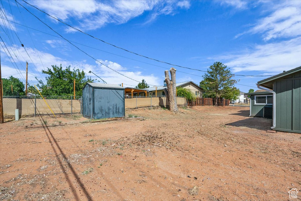 View of yard with a storage unit