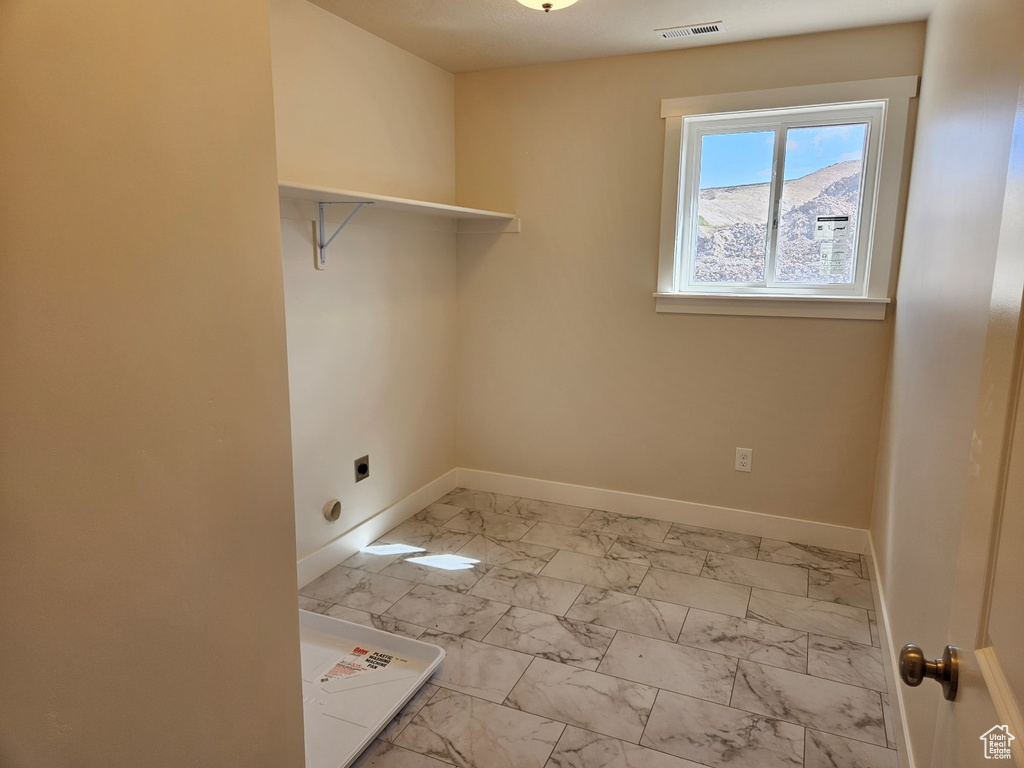 Laundry area with a mountain view and electric dryer hookup